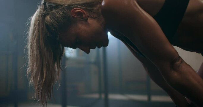 Fitness healthy woman tired after strength training exercise at gym. Slow motion: Close up of tired female fit model with standing and relaxing after intense workout. 