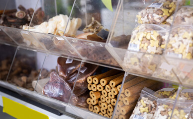 Closeup of various delicious dog feed and treats on showcase in pet store