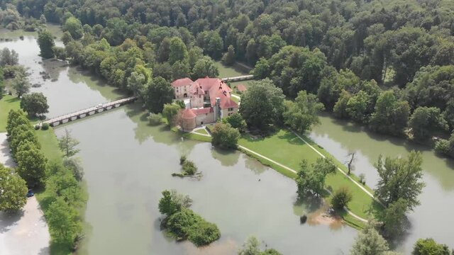 Review of a Castle Otočec. Slovenian castle. Beautiful Otocec castle in the nature forest near river in Slovenia. Five star hotel and restaurant in Otocec, Slovenia.