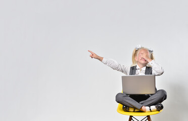 Girl child feels ashamed from what he saw in a laptop and points a finger at the empty space for...