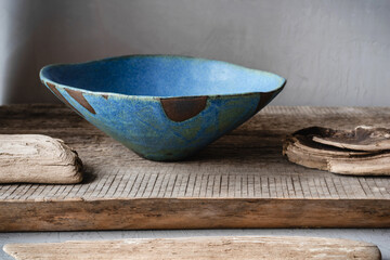 Handmade ceramics in the style of wabi sabi. Blue clay bowl with an abstract pattern.