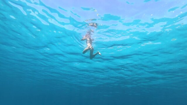 woman swimming in mediterranean sea under the water