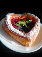 Delicious Heart-shaped Cakes Puff Pastry With Raspberries And Mint On Black Background