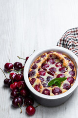 Clafouti cherry pie on rustic wooden table