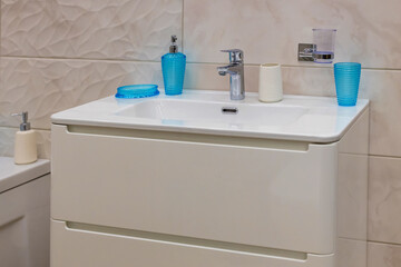 Bathroom interior sink with modern design in a modern residential building. Modern white bathroom sink with a tap.