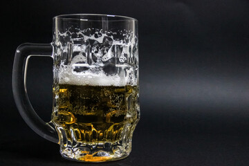 mug of beer on a dark background with nuts