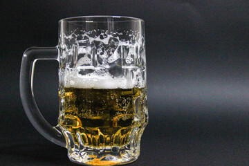 mug of beer on a dark background with nuts