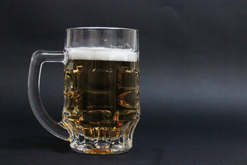 mug of beer on a dark background with nuts