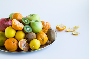 Fresh,ripe group of fruits in metal tray on white,close up.