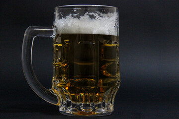 mug of beer on a dark background with nuts