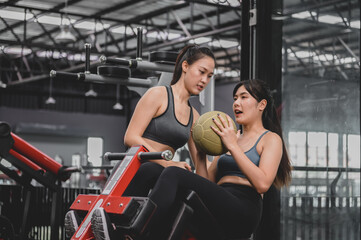 Fototapeta na wymiar Asian woman exercise and lifestyle at fitness gym. Sporty woman workout with trainer. Wellness and healthy for bodybuilding.