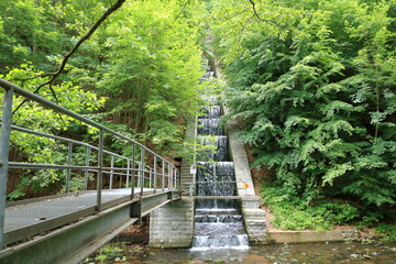 mountain river in the forest with waterfall and concrete wall near Dresden