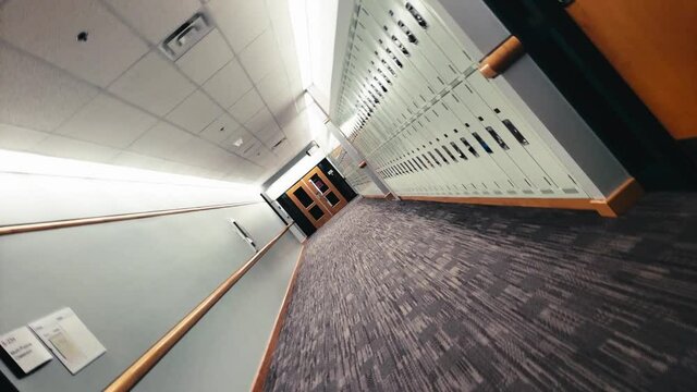 Spiral Vertigo twisted dizzy empty school hallway, with carpeted floors, and fluorescent lighting, lockers, no people in sight, and all class rooms, audioriums completely empty. 1-2