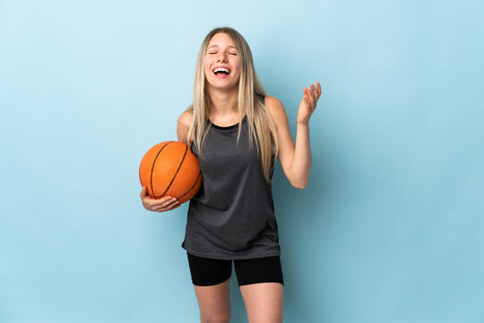 Young Blonde Woman Playing Basketball Isolated On Blue Background Laughing