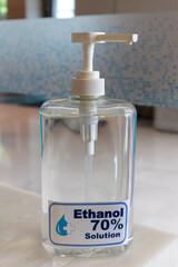 70% ethyl alcohol in the bottle placed on wood table.