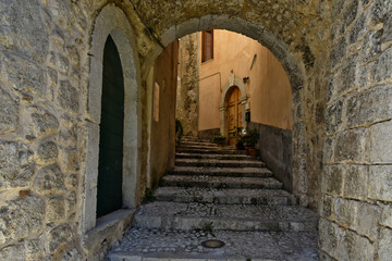 Fototapeta na wymiar A narrow street in the old buildings of San Donato Val di Comino, a medieval village in the Lazio region.