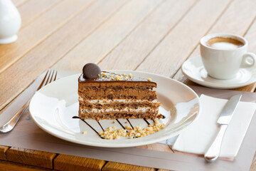 Chocolate cake and coffee served on the restaurant table