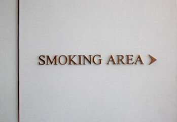 The directions text  "Smoking Area" on the gray wall.