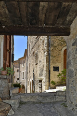 Fototapeta na wymiar A narrow street in the old buildings of San Donato Val di Comino, a medieval village in the Lazio region.