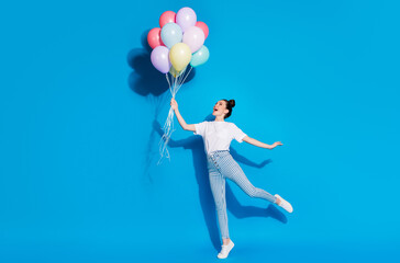 Full length body size view of nice attractive cheerful cheery glad girl jumping holding in hand...