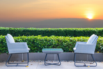 Two chairs for relaxing with natural at beautiful  sunset and golden sky. Social distacing or relaxign concept.