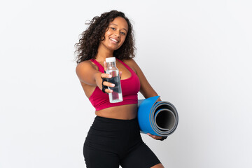 Teenager cuban girl isolated on white background with sports water bottle and with a mat