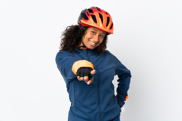 Teenager cyclist woman isolated on white background pointing front with happy expression