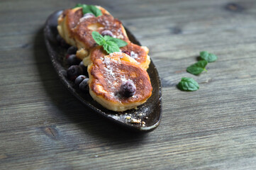 Cottage cheese pancakes with berries, mint dusted with sugar