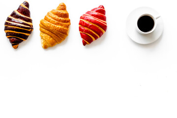 Croissants with coffee - breakfast on white table top view