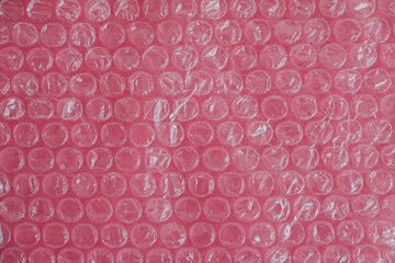 Packaging with air bubbles on a pink background. Bubble wrap texture, packaging, air bubble film....