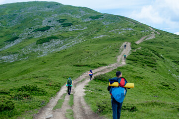 a group of tourists walking the trail to the top of the mountain