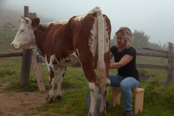 girl gets natural milk on a farm in the carpathian mountains