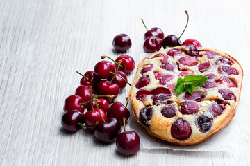 Clafouti cherry pie on rustic wooden table