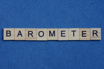 text on gray word barometer in small wooden letters with black font on a blue background