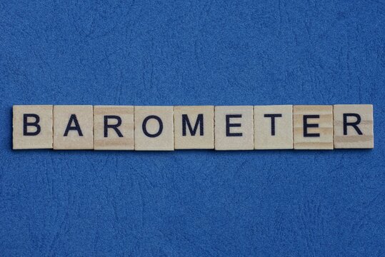 text on gray word barometer in small wooden letters with black font on a blue background