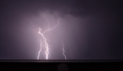 night shooting of a thunderstorm over the sea, photography of lightning