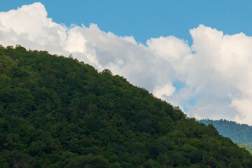 white clouds over the mountains as a landscape