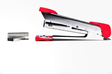 Pink stapler and staples isolated on white background. Office work equipment concept