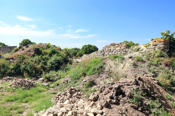 Fototapeta na wymiar Ruins of stone fortress wall in ancient Troy city, Turkey