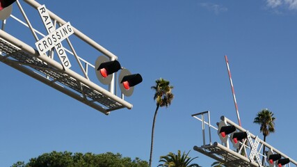 Level crossing warning signal in USA. Crossbuck notice and red traffic light on rail road...