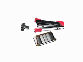 Pink stapler and staples isolated on white background. Office work equipment concept