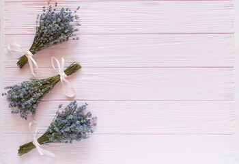 Lavender bouquets on pink wooden background. Top view,flat lay