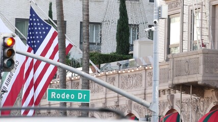 World famous Rodeo Drive Street Road Sign in Beverly Hills against American Unated States flag. Los...