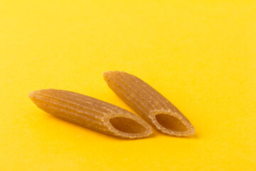 Pasta from hard wheat. Italian pasta on yellow background,  place for text.