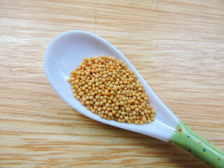 Yellow mustard seeds in isolated background