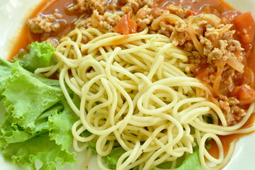 spaghetti dressing fried chop pork and slice tomato in ketchup sauce on plate 