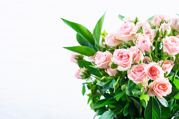 Bouquet of several branches of pink roses. Background of pink roses
