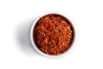 Isolated dried spice saffron in a white bowl
