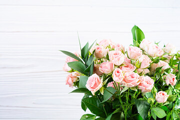 Bouquet of several branches of pink roses. Background of pink roses