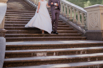 groom with bride on stairs near the building